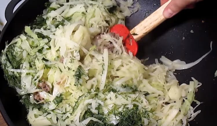 Add cabbage to the forcemeat in the pan.