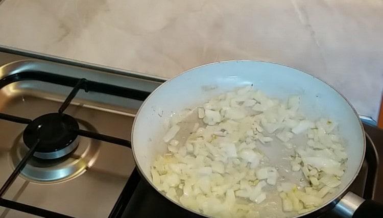 Fry the onion in a pan until golden brown.