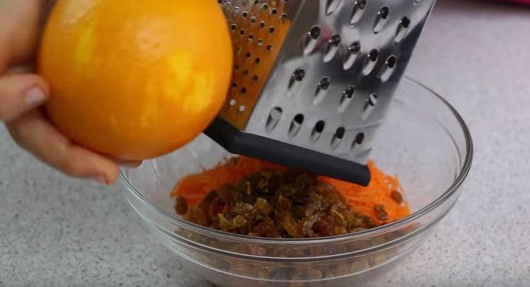 Add raisins to grated carrots and rub the zest of orange to them.