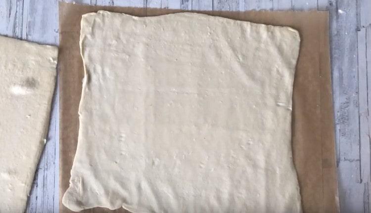 We spread one layer of dough on parchment.
