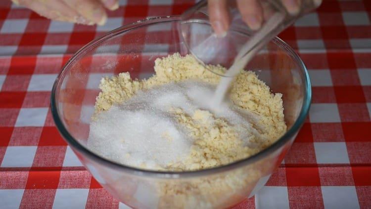 Grind the butter and flour into crumbs and add sugar.