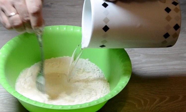To prepare the dough, mix water, flour and baking powder.