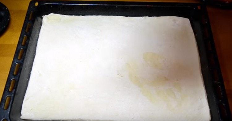 Roll the dough thinly and transfer to a baking sheet.