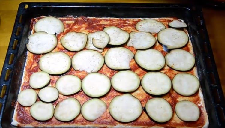 Lay out eggplant circles on top of the sauce.