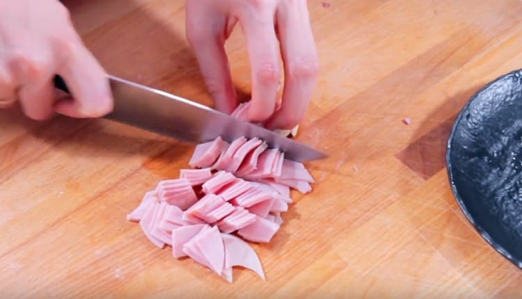 Cut the ham into squares.