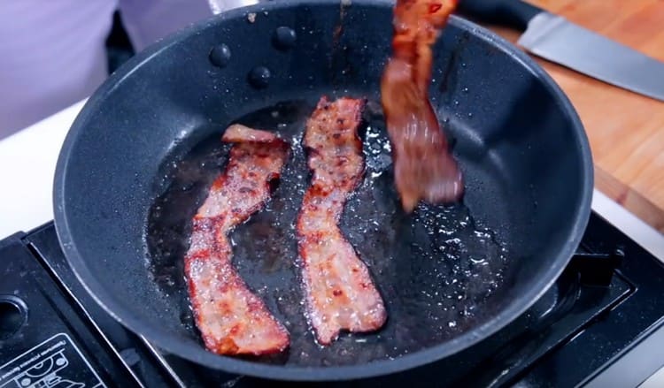 Fry the bacon until golden brown.