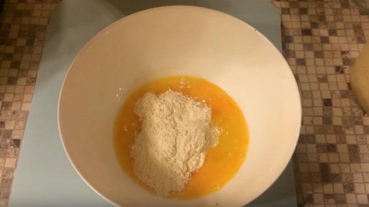 Add the flour to the eggs.