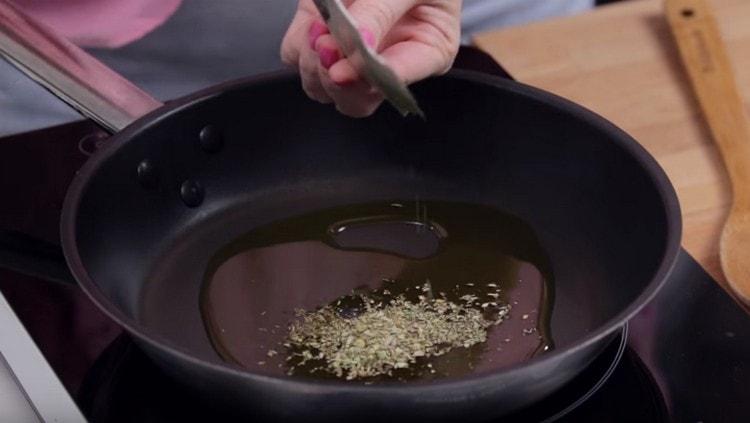 We heat vegetable oil in a pan and pour Provencal herbs into it.