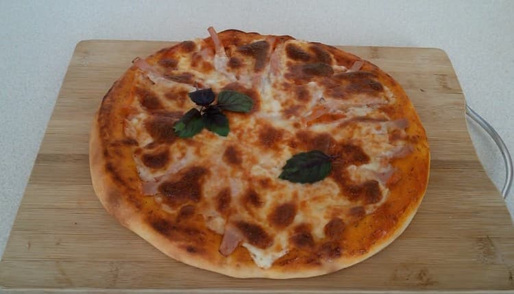 Fragrant pizza with mozzarella ready.