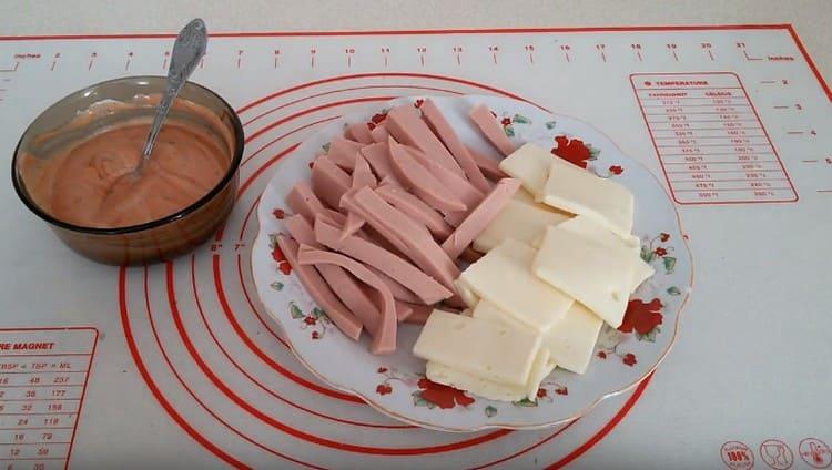 Cut into slices of mazarella and julienne cut sausage.
