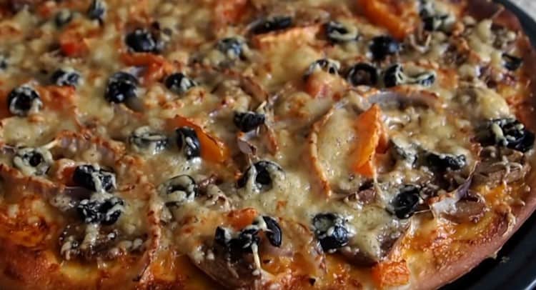 Fragrant pizza with mushrooms ready.