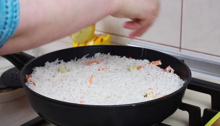Insert the garlic cloves into the rice, salt.