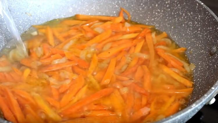 When the carrots become soft, add water to the pan.