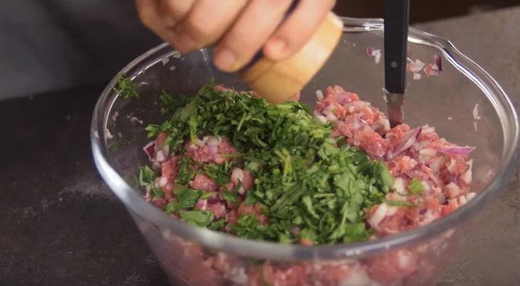 Ajoutez du sel, du poivre et des légumes verts hachés à la viande hachée.