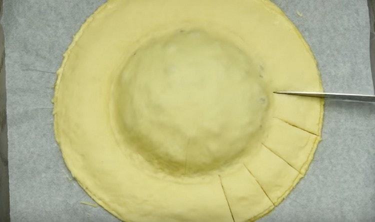 Cut the edges of the dough with a knife.