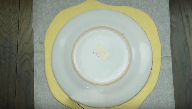 À l'aide d'un bol et d'un couteau, découpez un cercle pair dans la pâte.