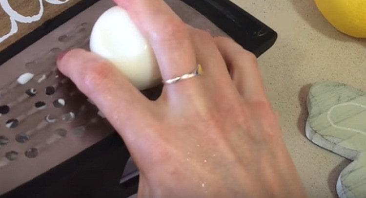 Three boiled eggs on a grater.