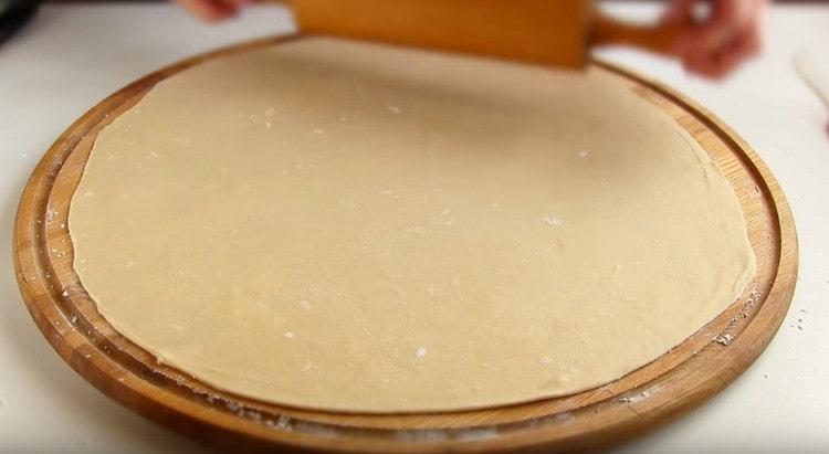 Each ball of dough is thinly rolled into a circle.