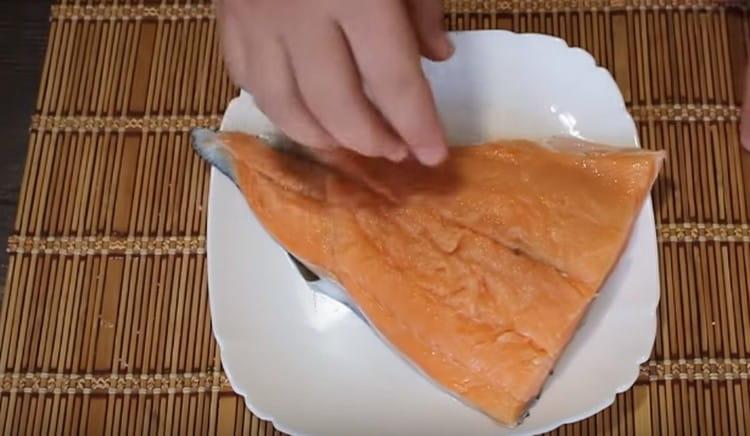 We wash and dry the salmon fillet, remove the bones in it.
