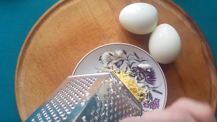 Three boiled eggs on a fine grater.