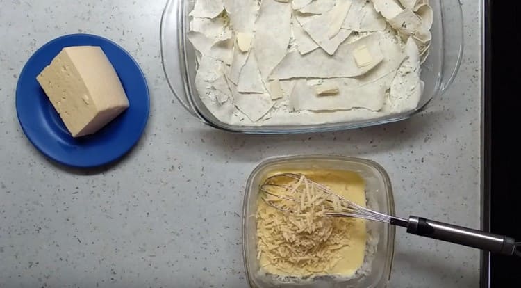 Preparación para el relleno del pastel del huevo. crema agria y queso rallado.