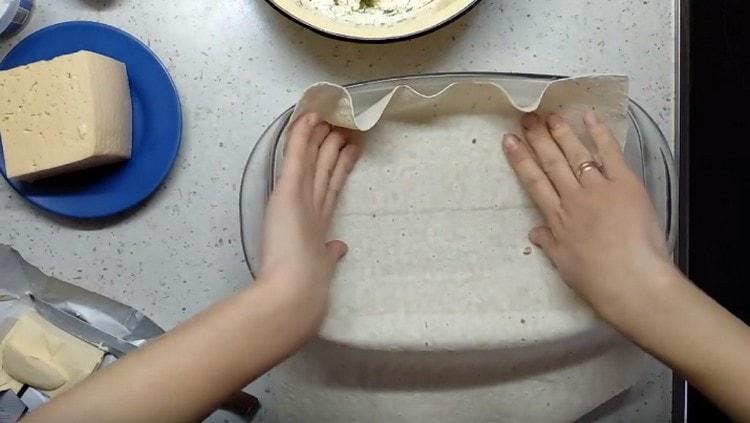 At the bottom of the form we lay pita bread.
