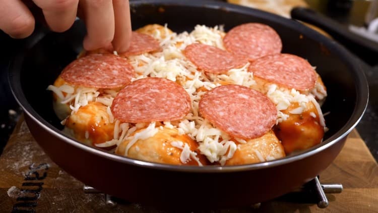 On top of the cheese we lay out circles of sausage.