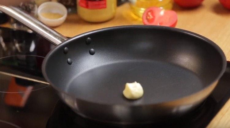 We heat the pan with a piece of butter.