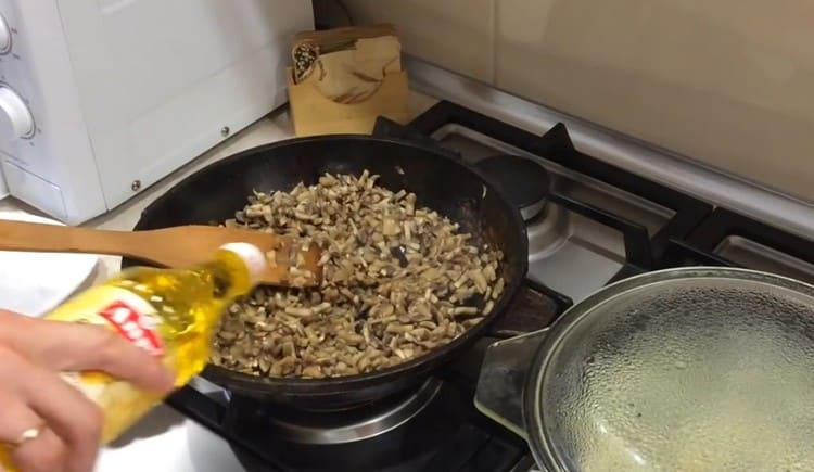 Lorsque tout le liquide sort des champignons et s’évapore, nous leur versons un peu d’huile végétale.