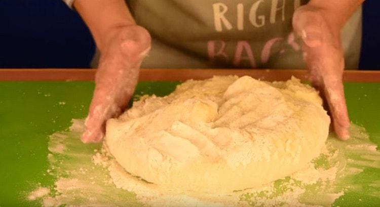 Transfer the dough onto a work surface and knead until it stops sticking to your hands.