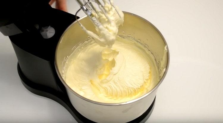 To prepare the cream, beat the softened butter with condensed milk.