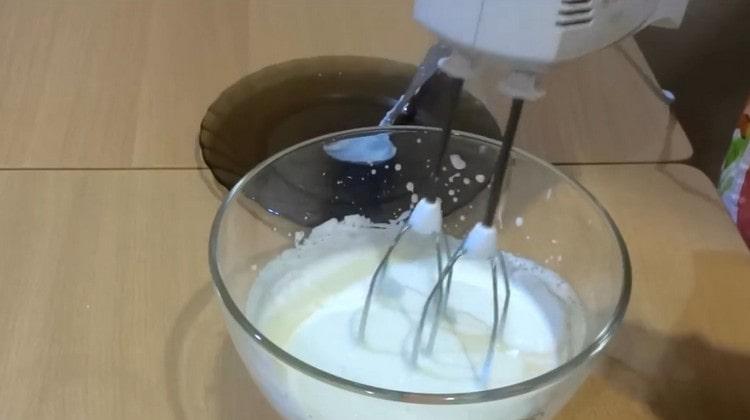 Beat sour cream with a mixer.