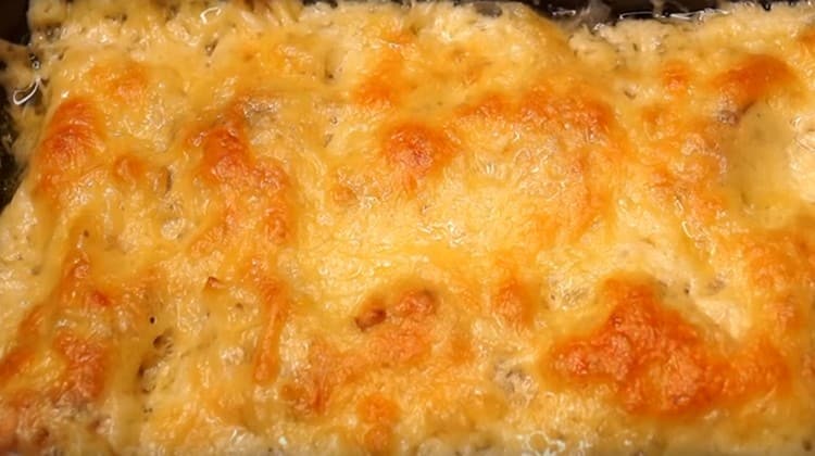 We bake pink salmon fillet in the oven under cheese until golden brown.