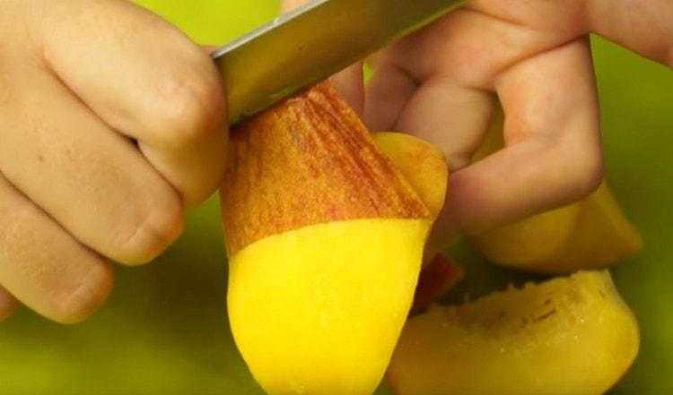 Cut slices of peaches and peel them.
