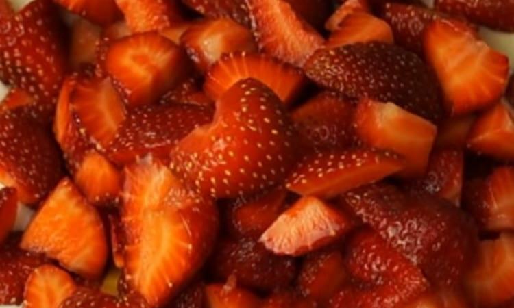 Cut strawberries into small pieces.