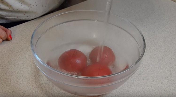 Pour the tomatoes with boiling water so that it is easier to peel them.