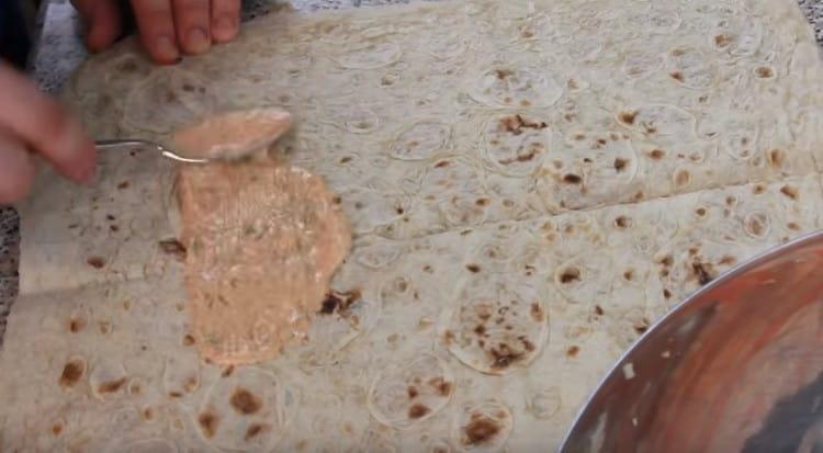 Lavash sheet like this is greased with sauce.