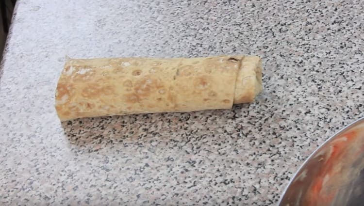 We wrap pita bread with a tight roll.