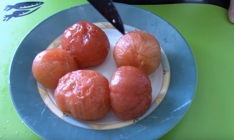 Versez les tomates avec de l'eau bouillante, puis retirez-en la peau.