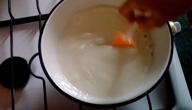 Cook the custard base of the cream until thickened.