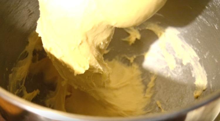 Add softened butter to the dough and knead well.