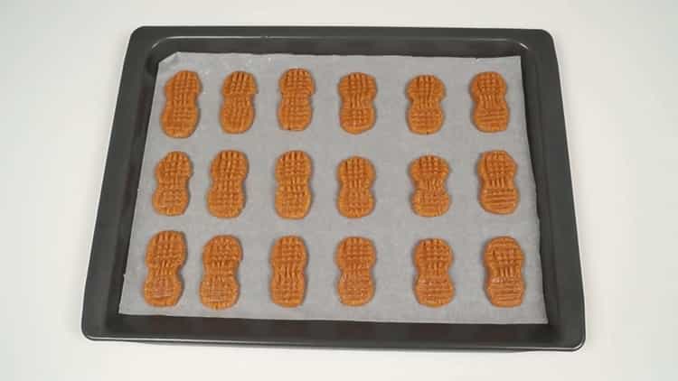 To make peanut cookies, preheat the oven