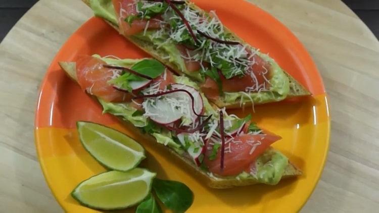 Hearty sandwiches with avocado and red fish are ready