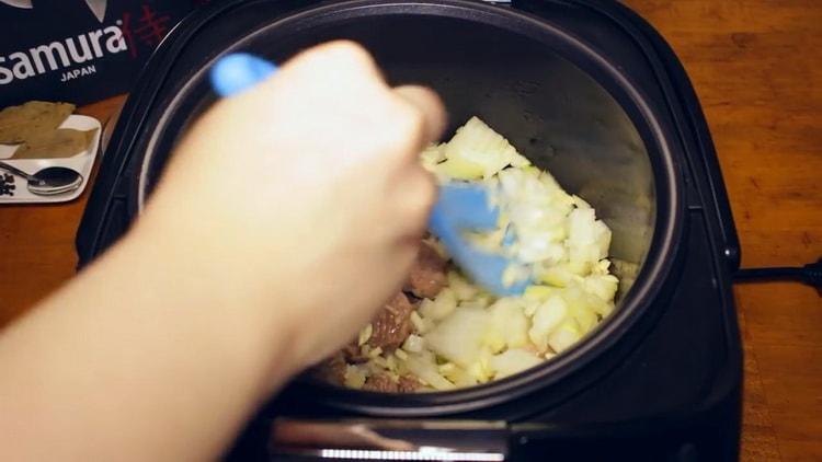 To cook beef goulash in a slow cooker, fry the onions