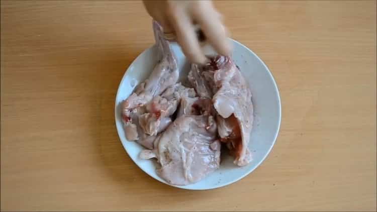 To cook a rabbit in a slow cooker, prepare the meat