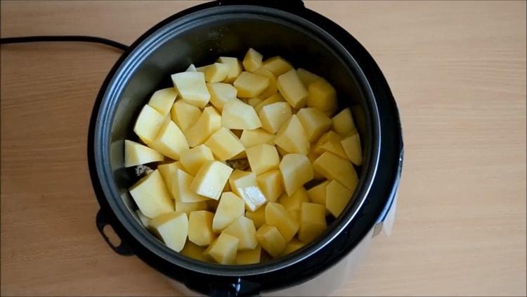 To cook a rabbit in a slow cooker, add potatoes