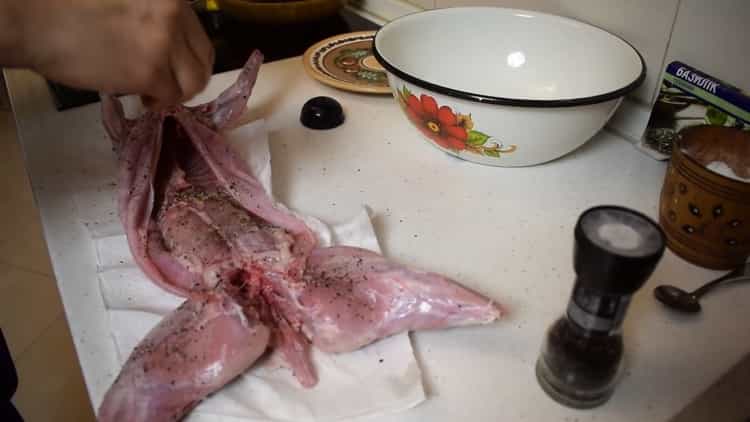 To prepare the rabbit in foil in the oven, rub the rabbit with spices