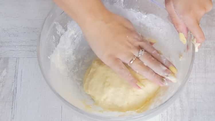 Knead the dough to make a Laurent pie with chicken and mushrooms.