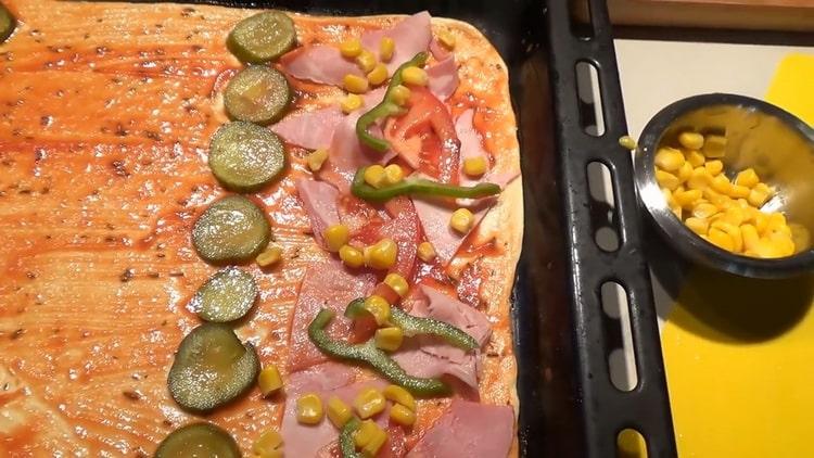 To make the pizza toppings, lay the corn