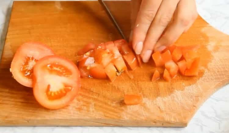 To cook vegetable stew with zucchini, chop the tomatoes